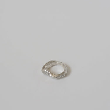 Small silver metal ring on a gray background