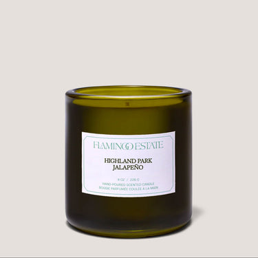 Green candle with a label on a light gray background