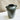 Green ceramic vase with two handles on a marble surface