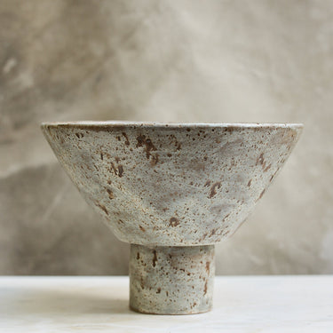 Ceramic bowl with textured surface on a neutral background