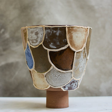 Ceramic vase with multicolored glaze on a neutral background