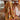 Patterned blanket draped over a wooden table in a dining room setting