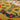 Close-up of a woven textile with floral patterns on a yellow background