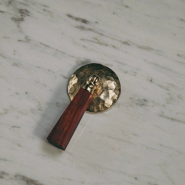 Brass door handle with wooden handle on a marble surface