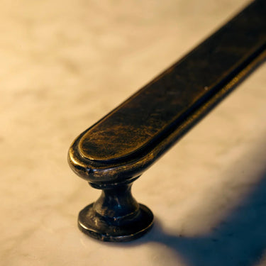 Close-up of a metal handle on a textured surface