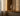 Glass vase on a wooden shelf with soft lighting and shadows