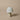 Mushroom-shaped lamp with ribbed design on a beige background