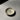 Small ceramic dish on a gray surface with a black background