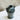 Black ceramic vase with two handles on a marble surface