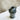Black ceramic vase with two handles on a marble surface
