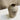 Textured ceramic vase on a marble surface with a neutral background