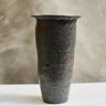 Textured ceramic vase on a neutral background