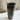 Black ceramic vase on a marble surface with a neutral background