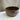 Brown ceramic bowl on a marble surface with a neutral background