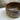 Brown ceramic bowl on a marble surface with a neutral background