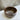 Brown ceramic bowl on a marble surface with a neutral background