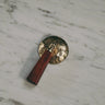 Brass door handle with wooden handle on a marble surface